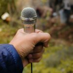 close up photography of person holding microphone